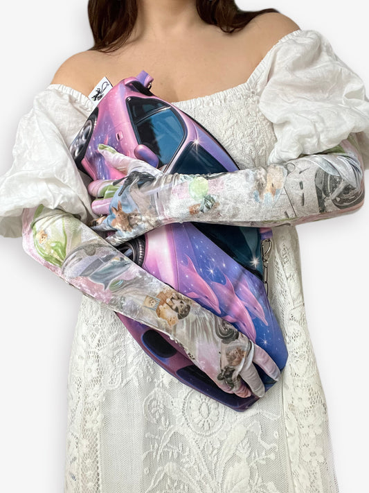 Person wearing a white off-shoulder dress with long opera gloves by CHIMERA.