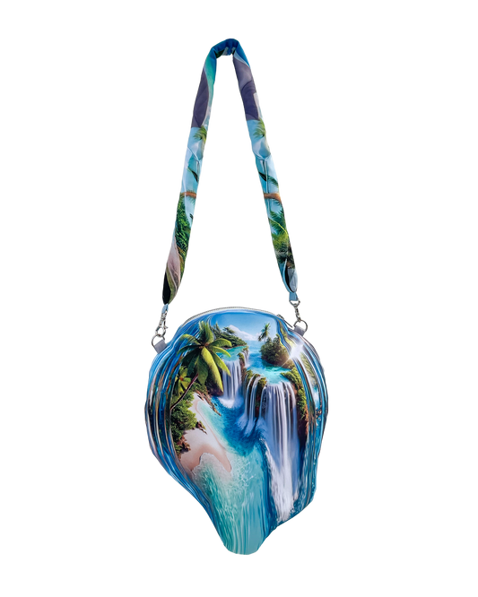 Tropical Globe Bag by Chimera Lab with tropical landscape print and soft sculptural form, hung by a padded printed shoulder strap.