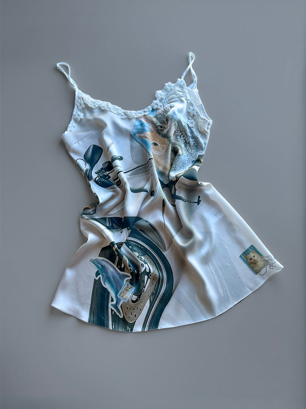 Mini Silk Slip Dress with a motorcycle and animal print with lace trim detailn on a grey background.