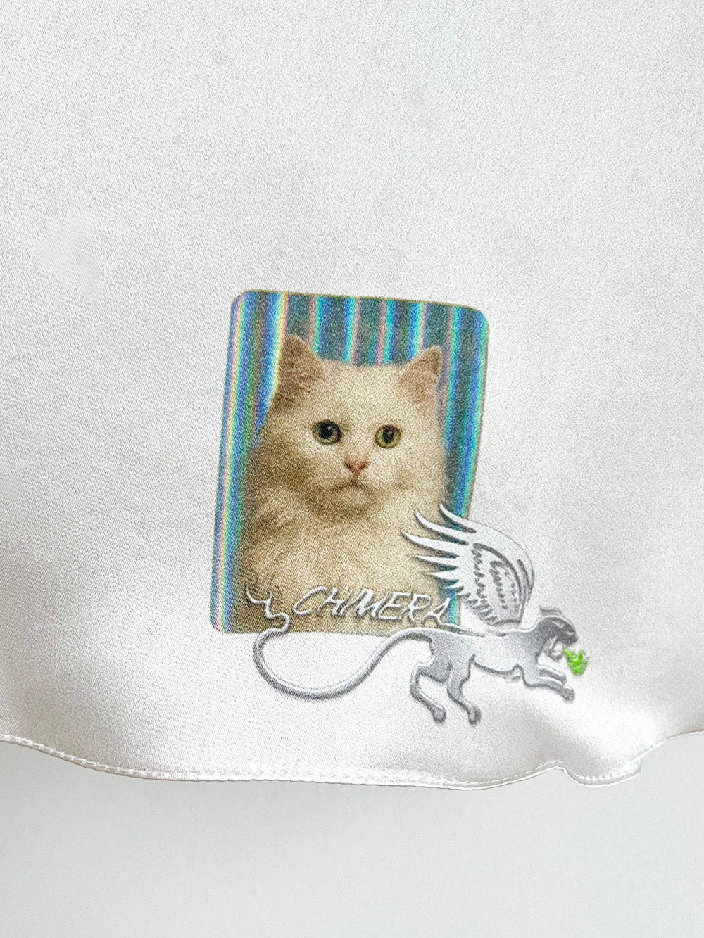Silky material close-up with a cat design and CHIMERA brand logo on a white background.