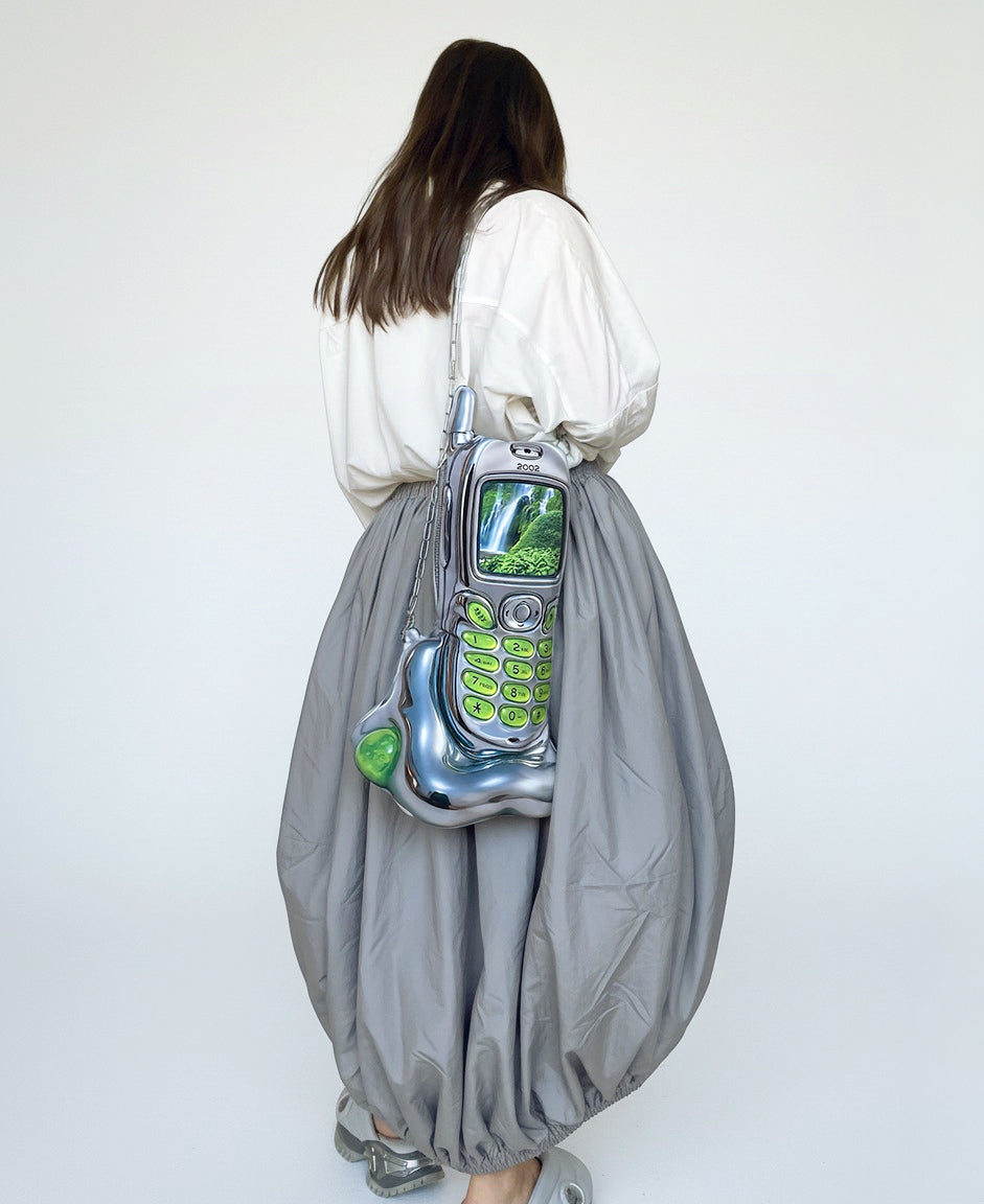 Back view of model wearing the Chimera Lab Nature Cell Bag, styled with oversized white shirt and grey baloon skirt