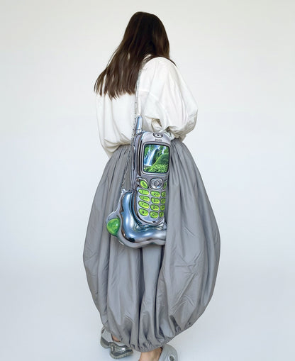 Back view of model wearing the Chimera Lab Nature Cell Bag, styled with oversized white shirt and grey baloon skirt