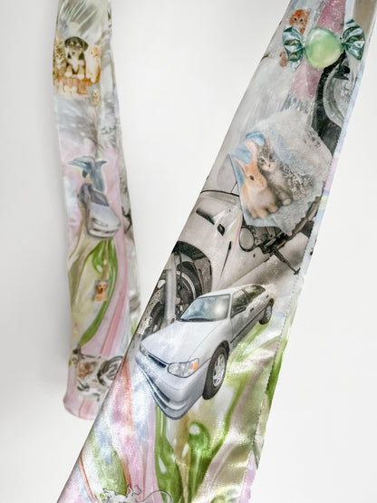 Closeup of long printed opera gloves with car and kitten print on a white background.