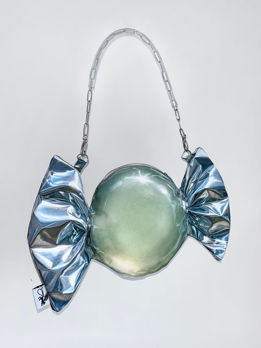Silver candy-shaped handbag on a white background.