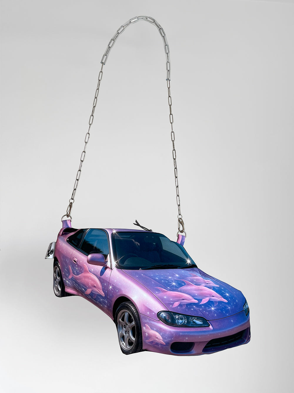 Y2K-inspired sports car handbag in purple and pink with airbrushed dolphin graphics and glossy photorealistic finish, chain strap, CHIMERA design.