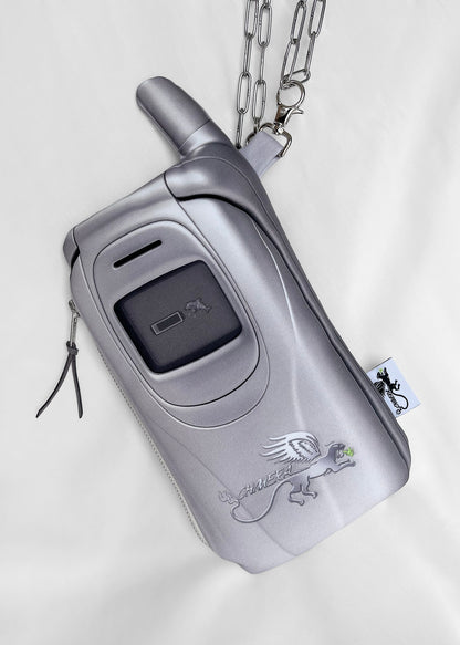 A silver metallic zippered phone-shaped pouch with a flip-out top, chain strap, and CHIMERA logo graphic, displayed on a white fabric background.