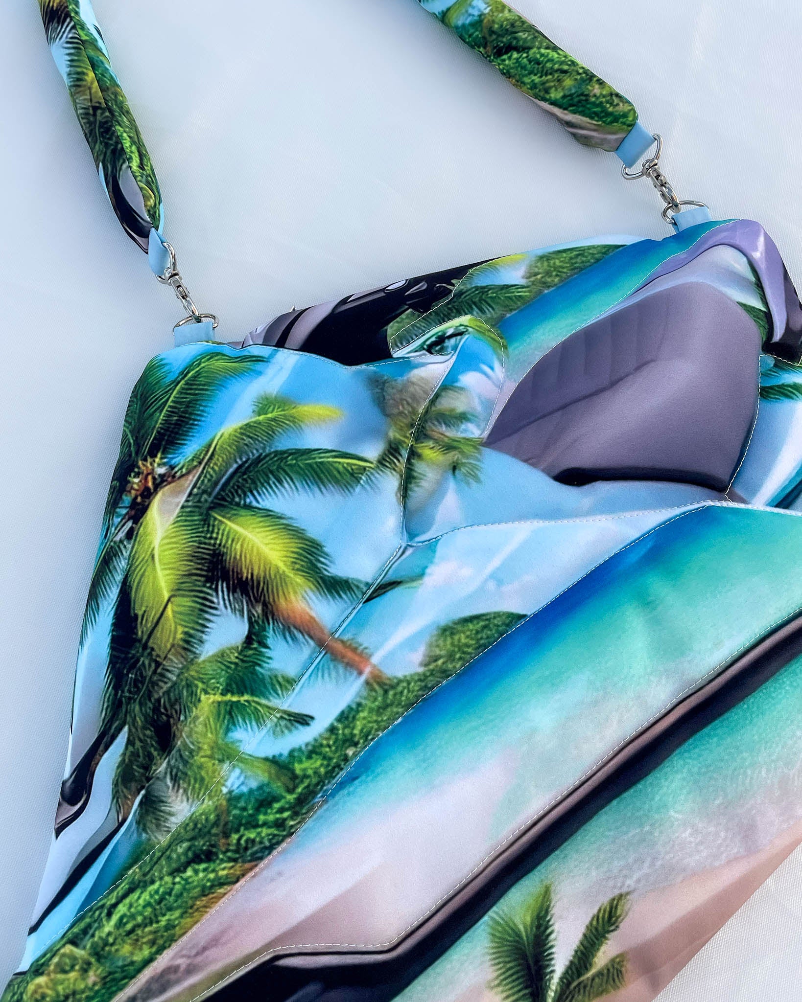 Close-up of Tropical Jetski Bag showing softshell texture, digital palm tree print, and padded sculptural form
