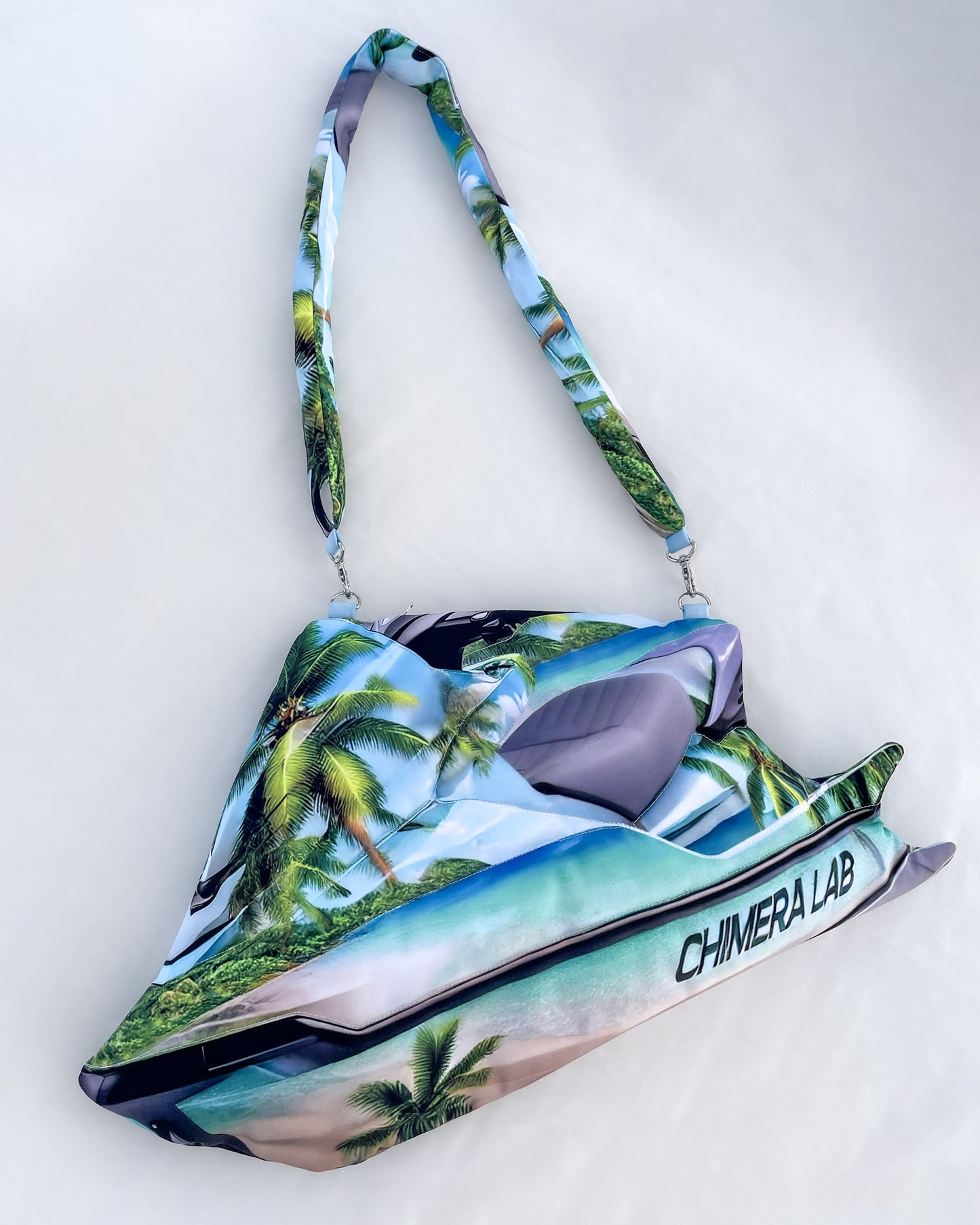 Tropical Jetski Bag laid flat, highlighting beachside jet ski silhouette, oceanic print, and Chimera Lab logo on the side