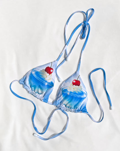 Blue bikini with cupcake design and cherries on a white background