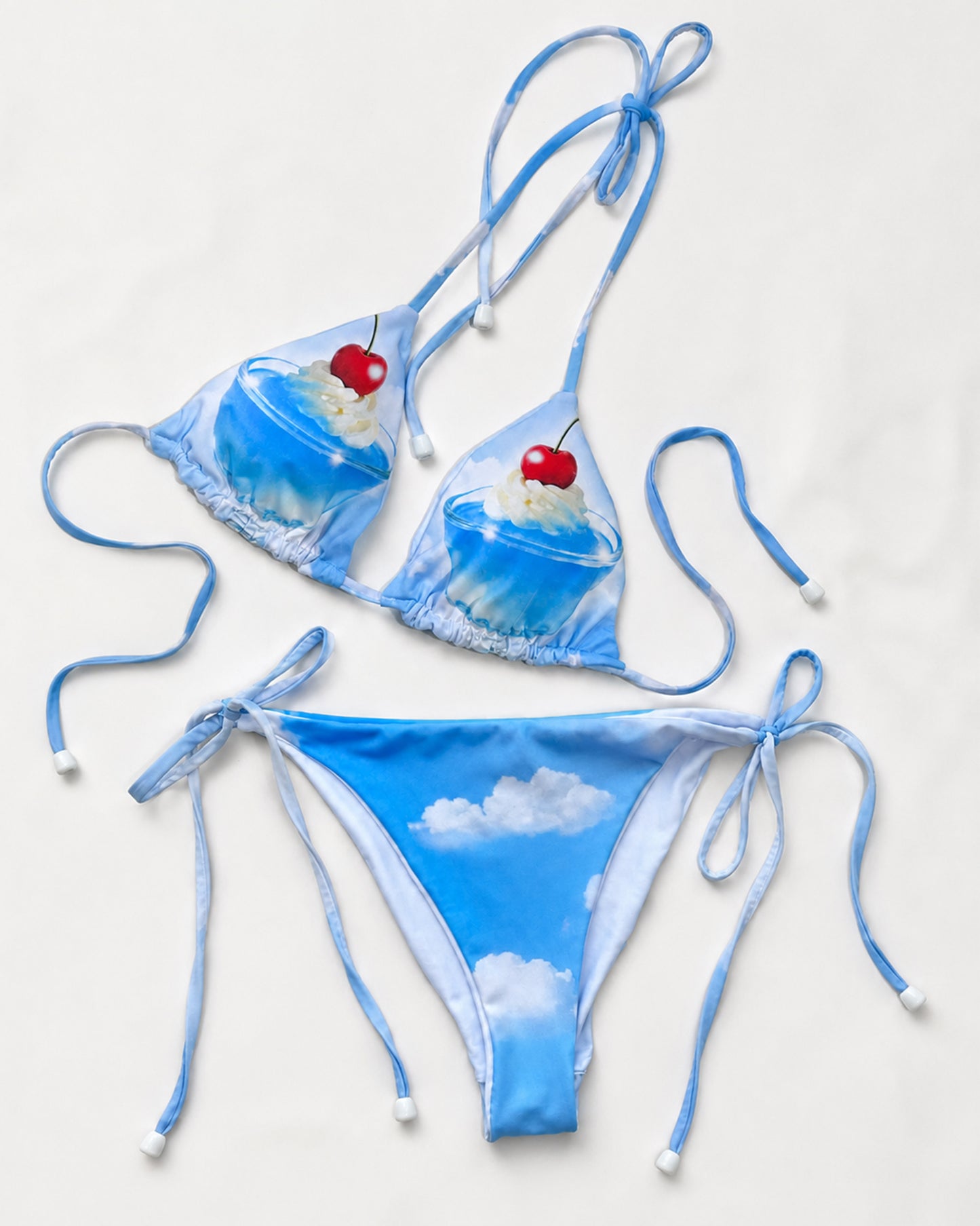 Blue bikini set with cloud and cherry design on a white background