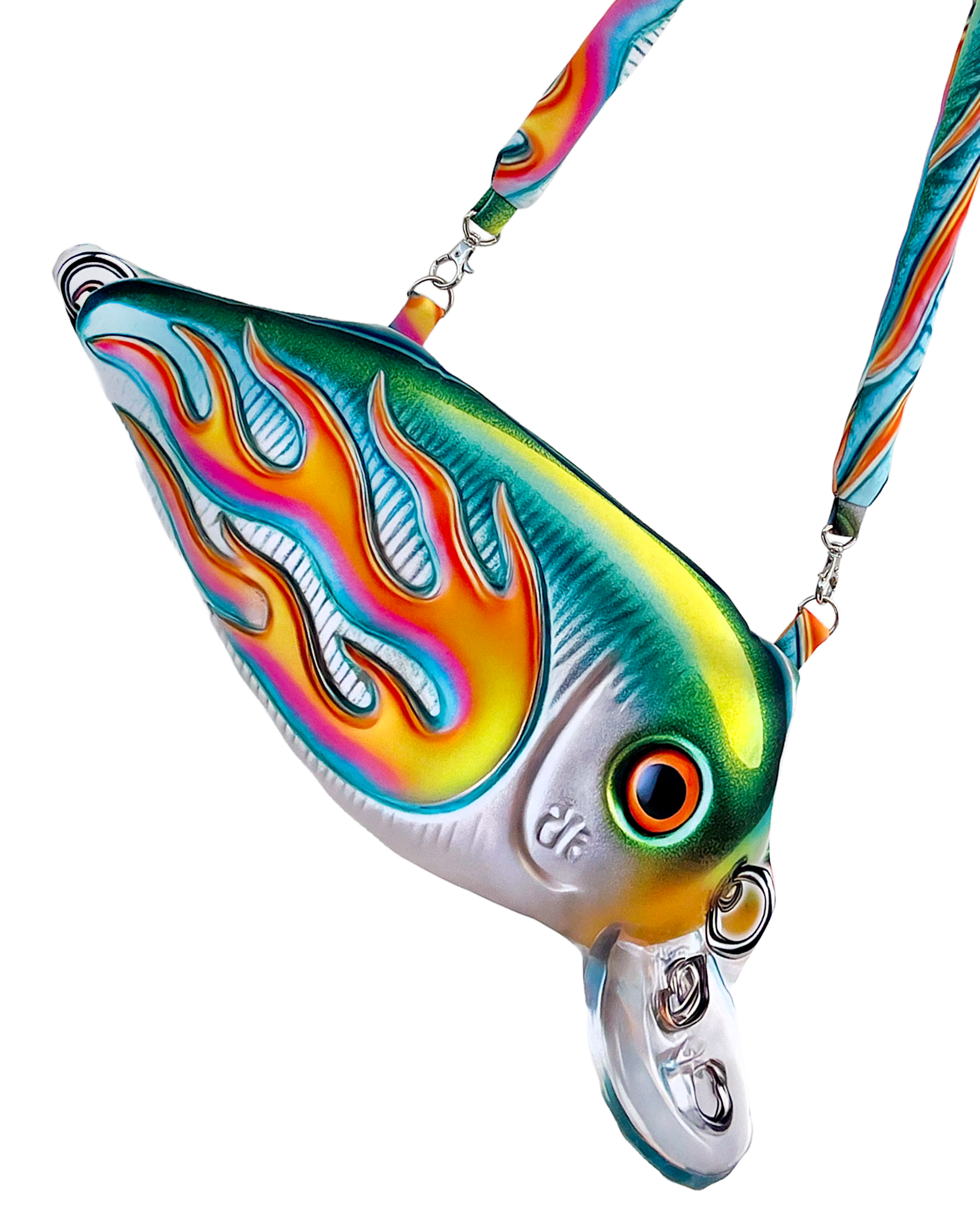 Close-up of the Moto Fish Bag by Chimera Lab, shaped like a 3D fishing lure with a chrome body and neon flame graphic, featuring a padded printed strap.