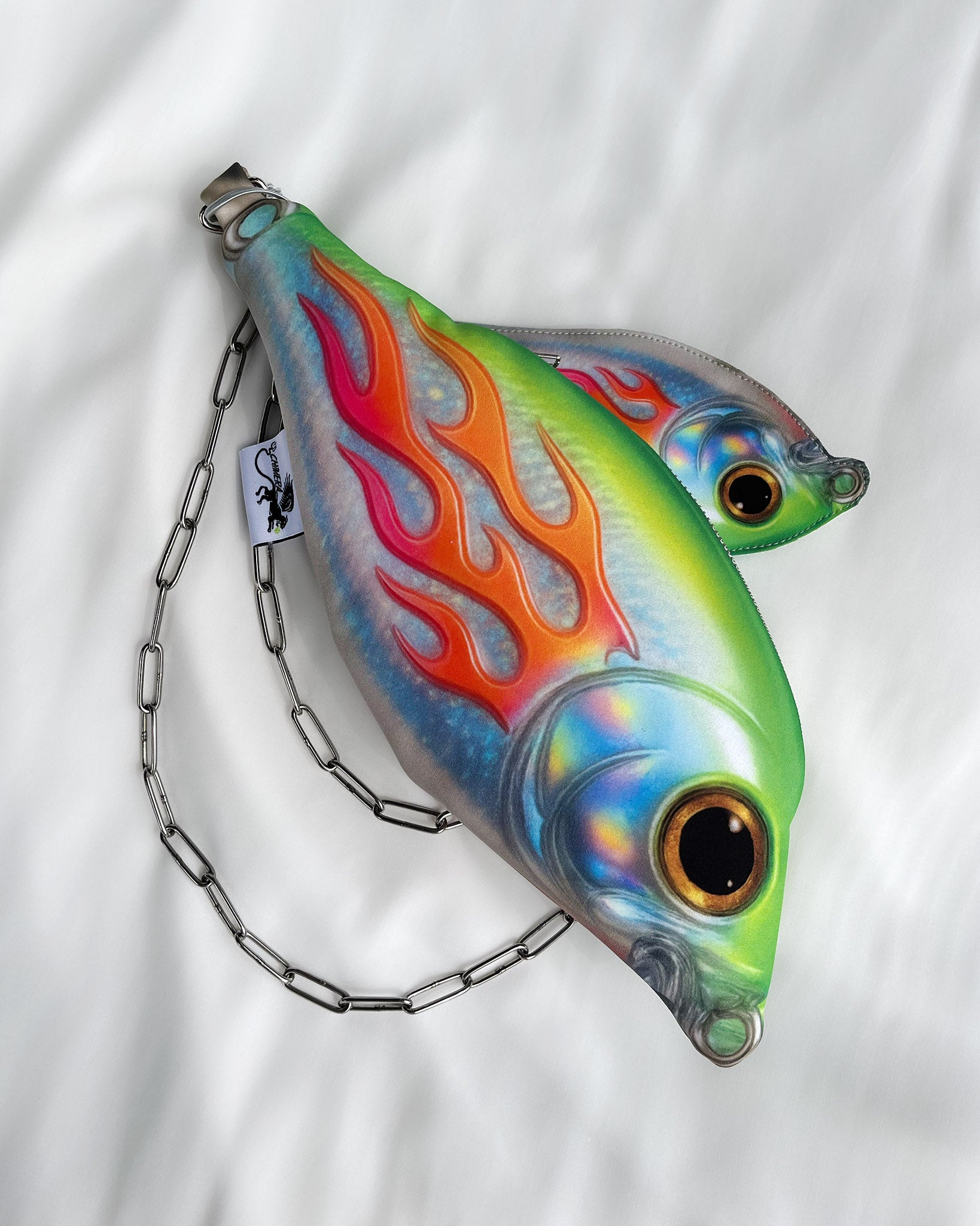 Baby Trophy Fish holographic mini pouch with neon flames and detachable 110 cm chain strap, displayed on white background.