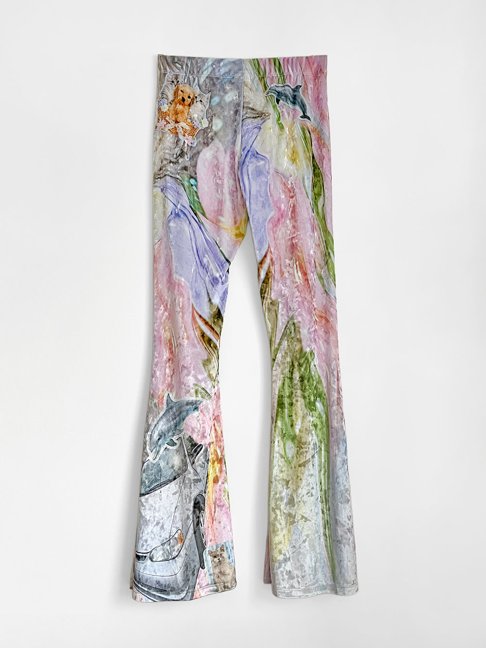 Velour flared pants with animal prints on a white background.