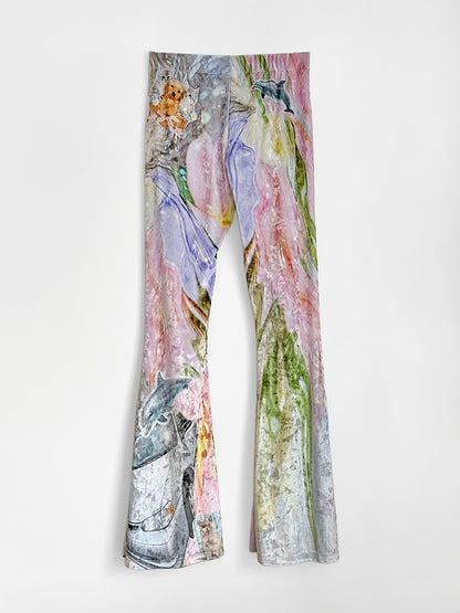 Velour flared pants with animal prints on a white background.