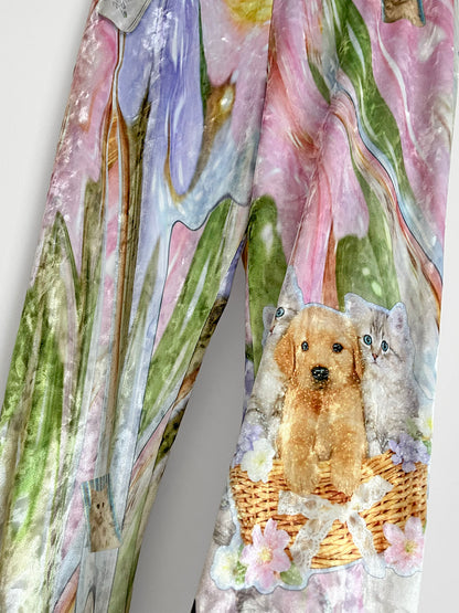 Colorful pants with a dog and cat design on a white background.