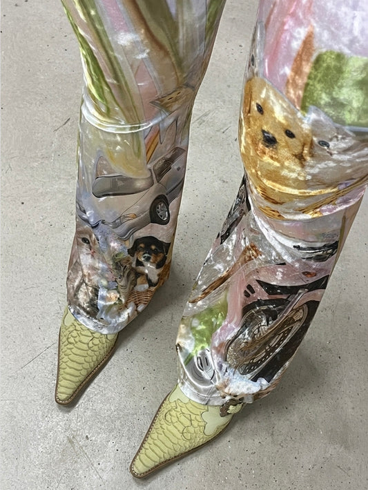 Velour printed flared leggings paired with lime green western heels on a concrete floor.