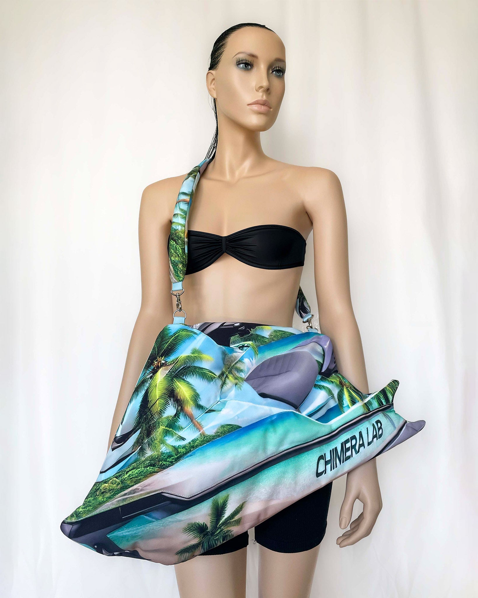 Mannequin wearing black bikini top and Tropical Jetski Bag with palm tree print, designed by Chimera Lab